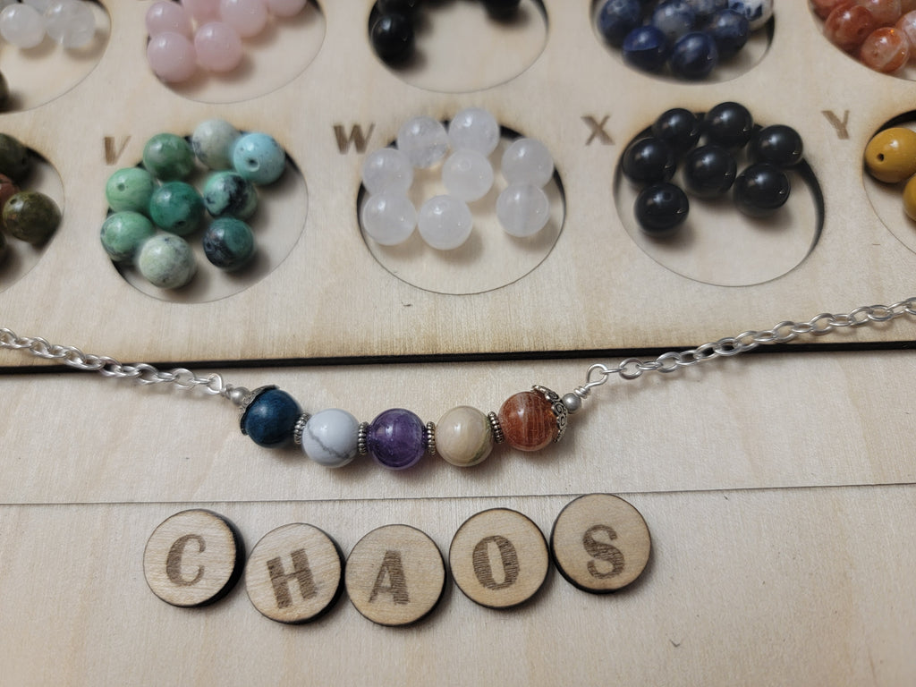 a necklace with beads spelling out "chaos"