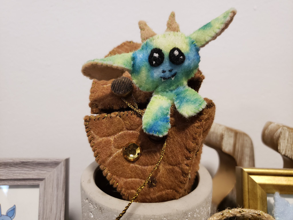 a felt gremlin in a felt egg