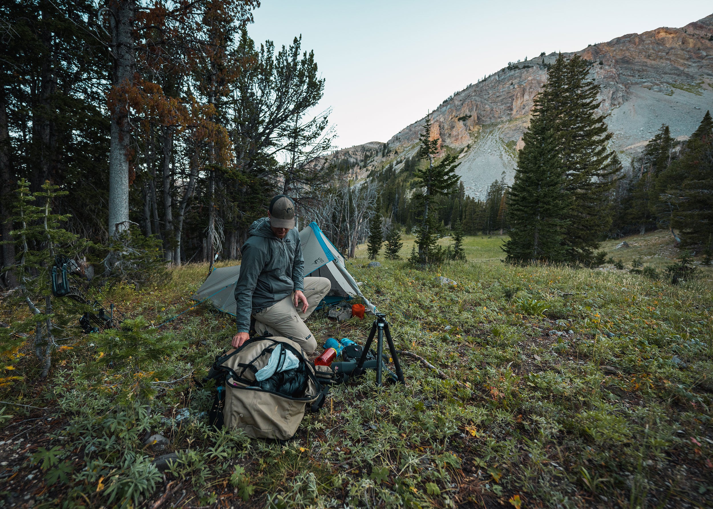 Hunter with tent in mountains