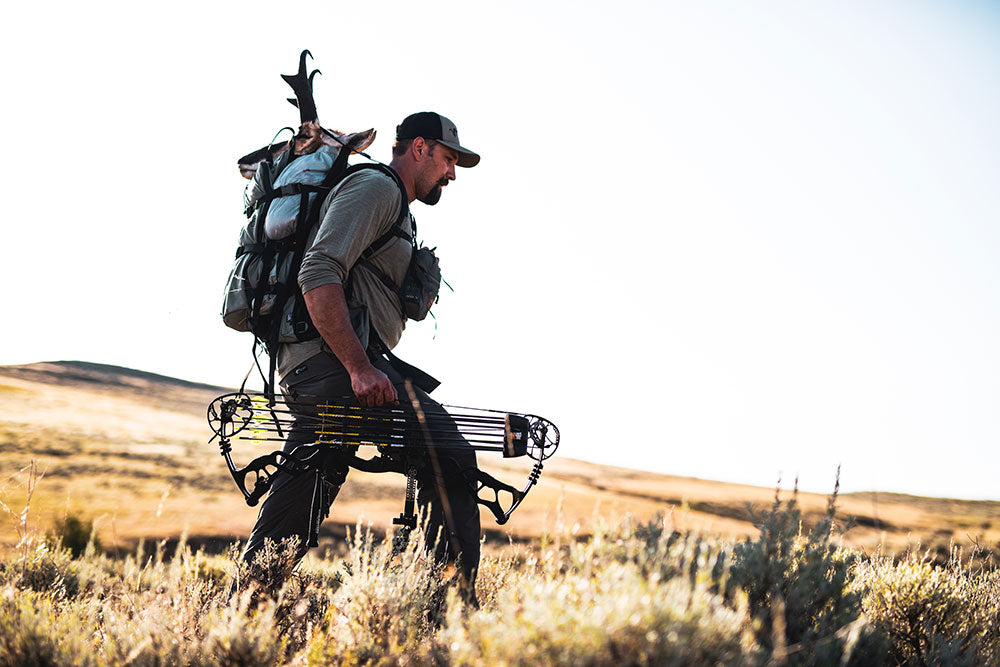 Hunter packing antelope in hunting pack