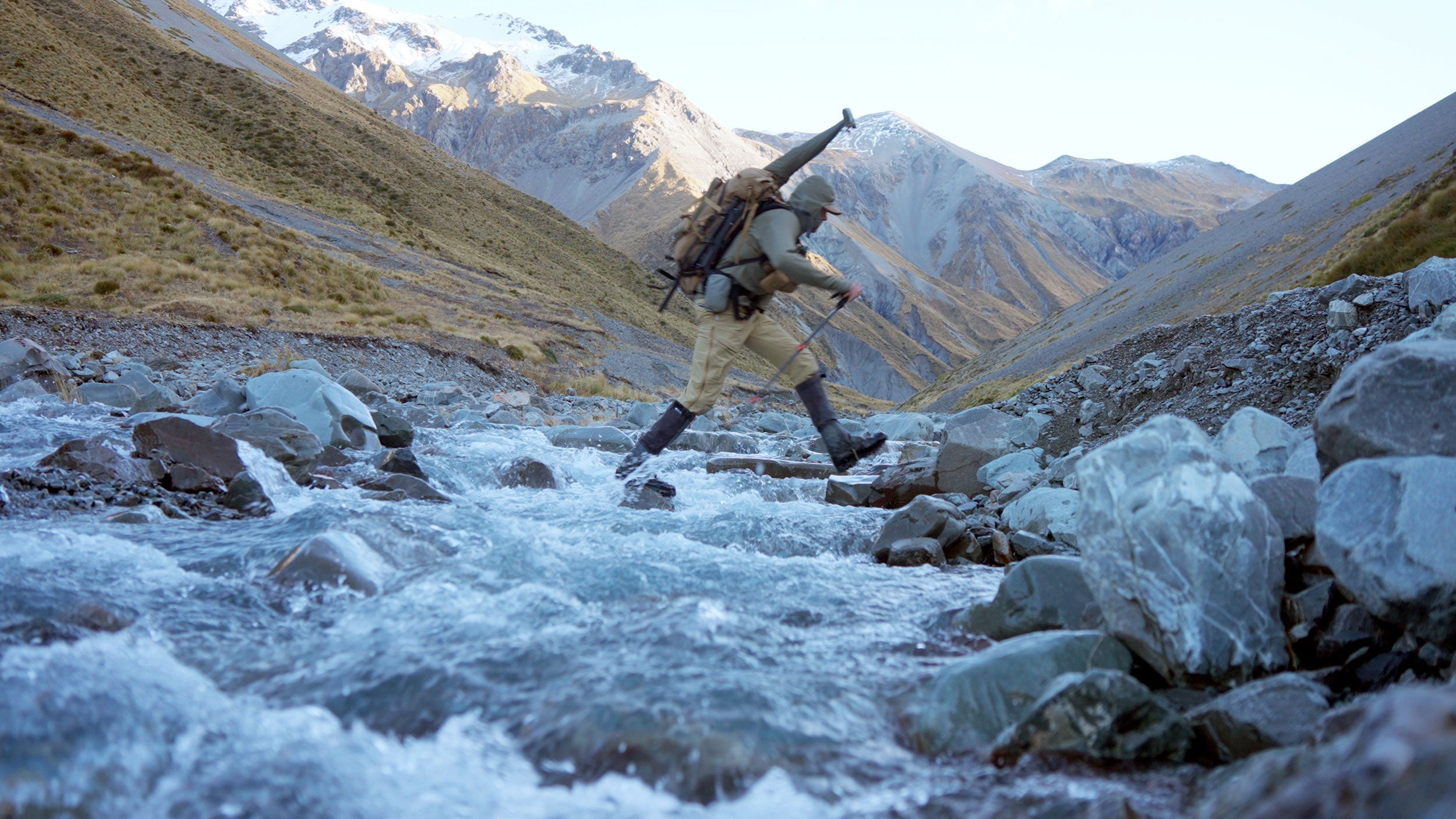 Hunter crossing river