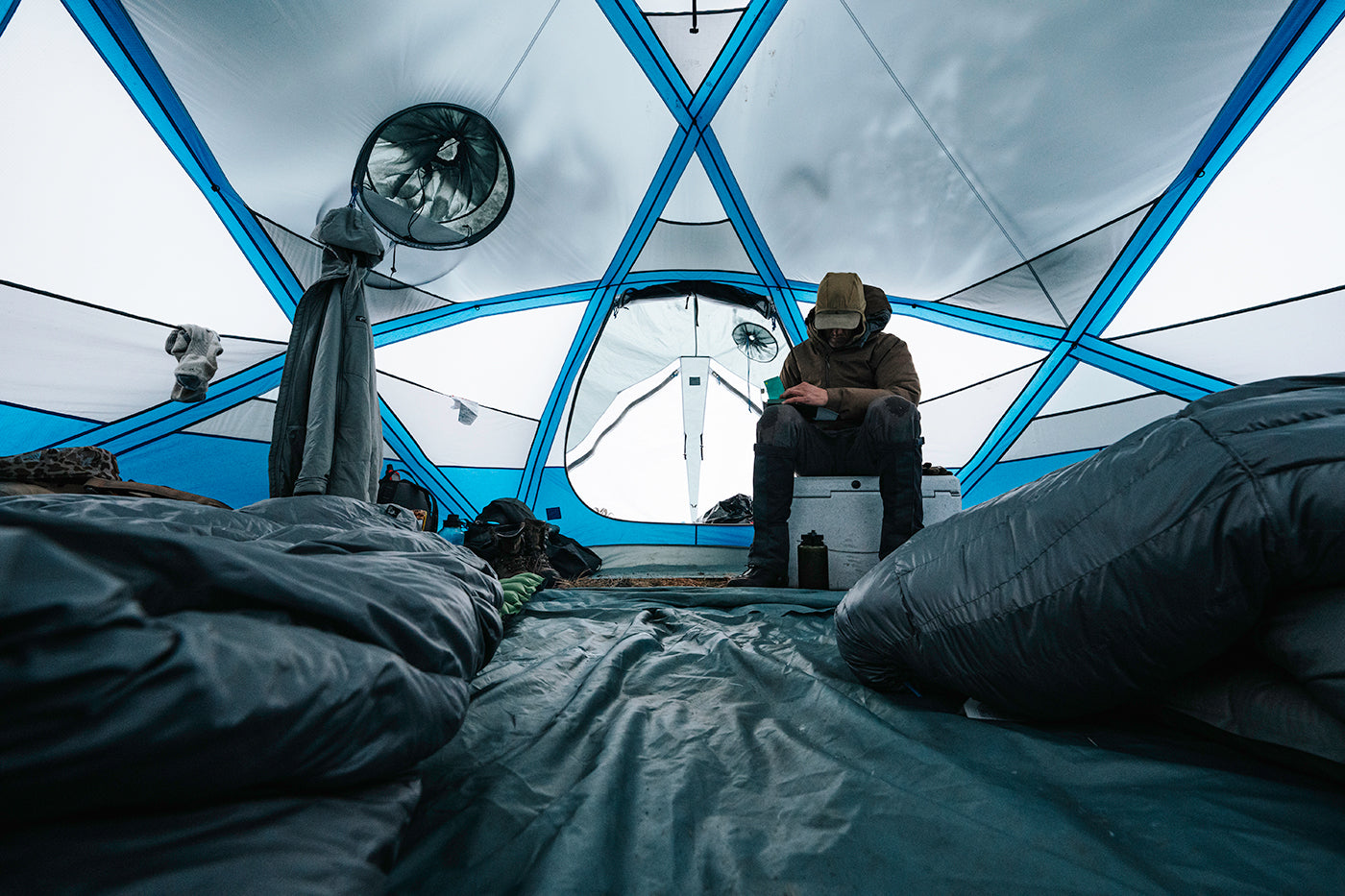 Hunter inside Stone Glacier Dome base camp hunting tent