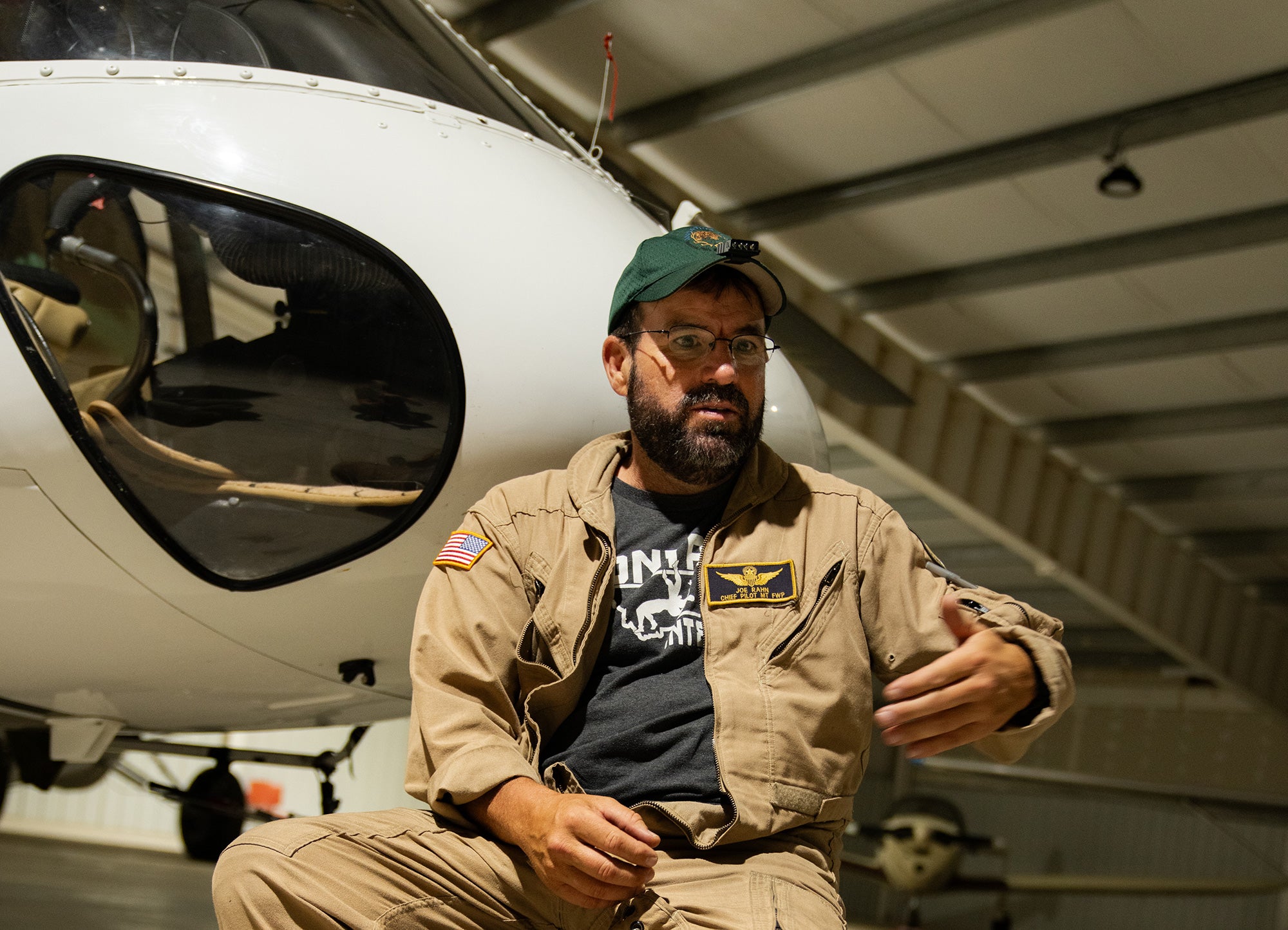 Montana FWP Aircraft Unit Bureau Chief/ Chief Pilot Joe Rahn holding court in the hangar after a survey in the Missouri River Breaks.