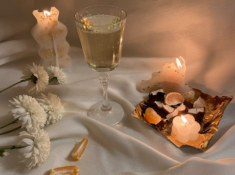 Romantic Beeswax candles on tray with glass of wine
