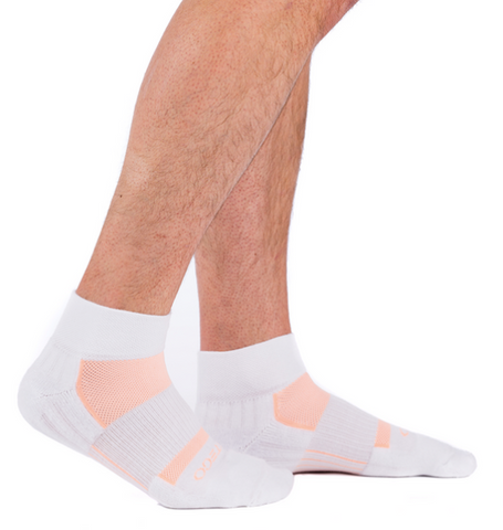 person wearing white ankle socks with peach accents