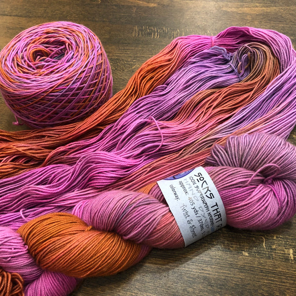 the same pink/orange yarn unskeined, skeined, and wound into a ball