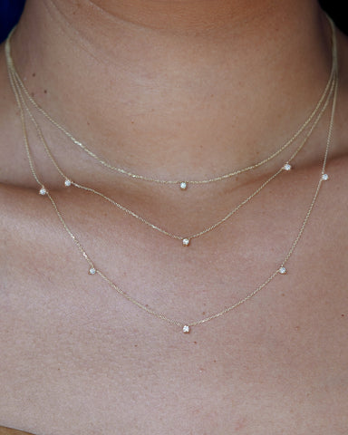 A model wearing a diamond cable necklaces layered