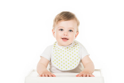 Baby wearing a baby bib against a white background.