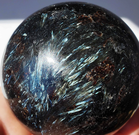 Arfvedsonite sphere with blue flashes