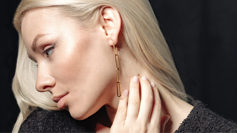 A pair of dangling earrings with a bohemian style, made with gold-tone metal