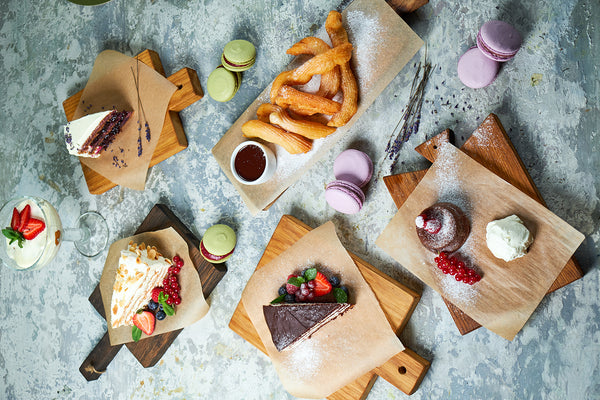 Wooden serving boards with desserts on top