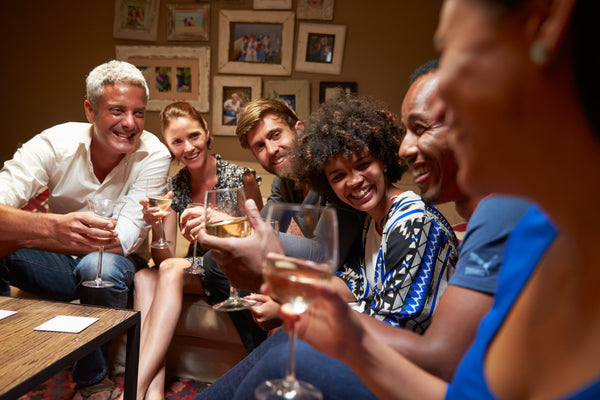 Group of friends enjoying drinks at a party