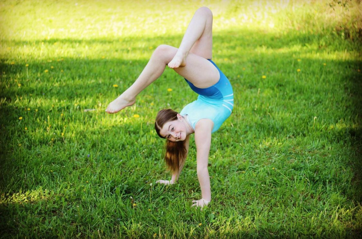 Gymnast Practices In Her Sleeveless Gymnastics Leotard