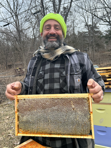 Founder Hany with bee hives.