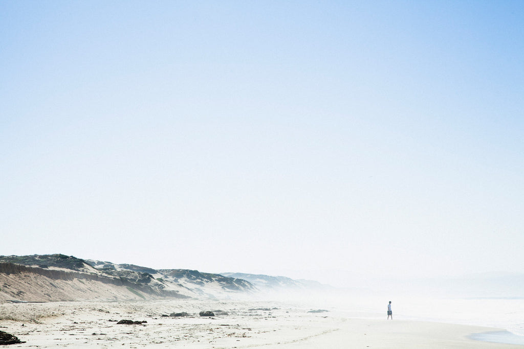 Fog rises above the beach in the early morning