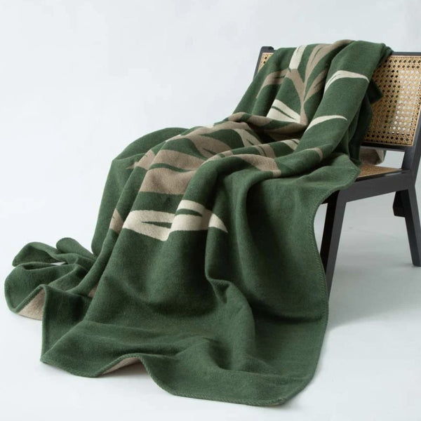 green cotton blanket on a chair