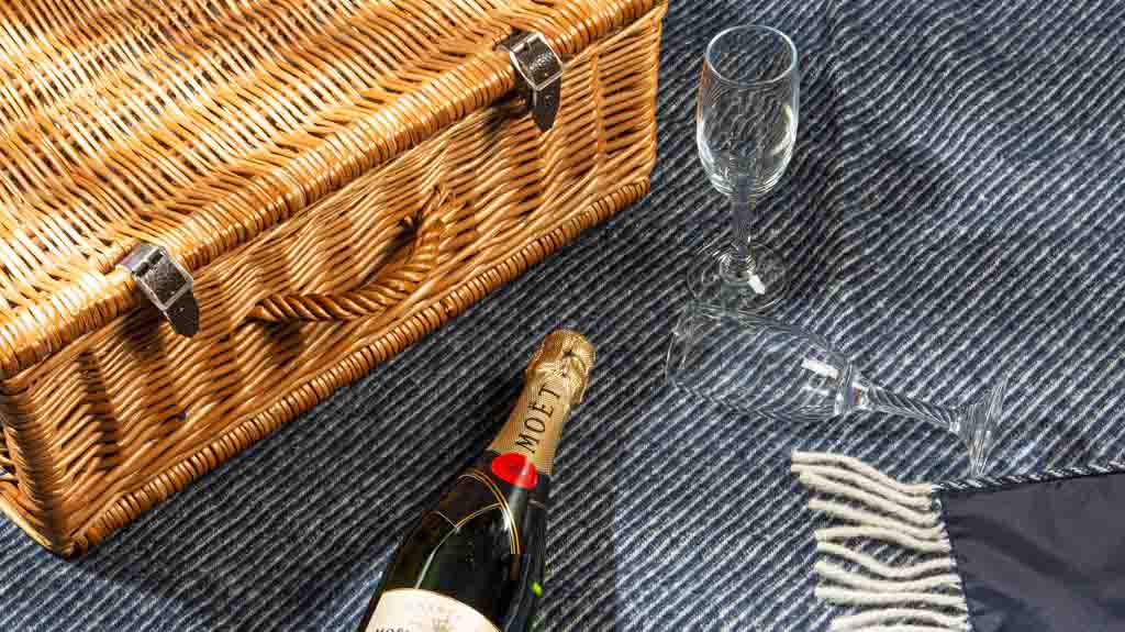 picnic basket on an outdoor blanket at night