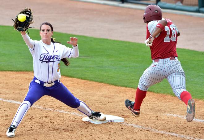 Softball first baseman stretching out for an out