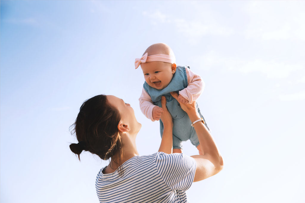 Mother and baby smiling | HealthMasters