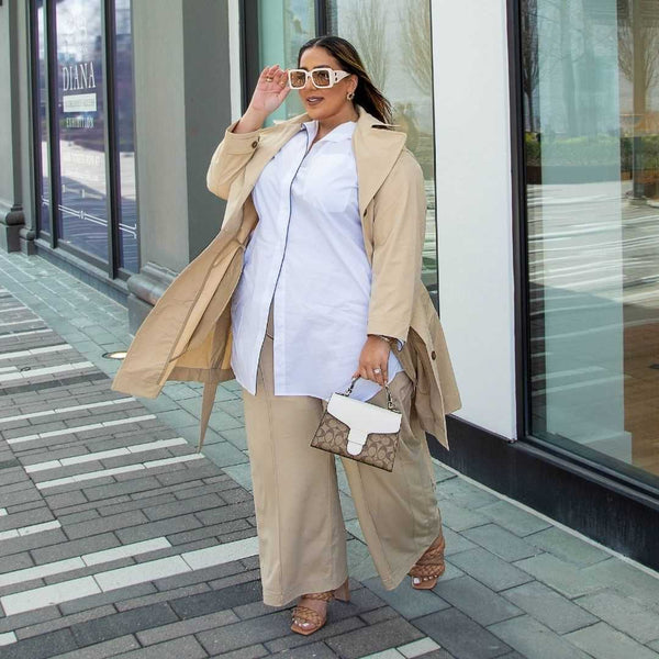 Model and Influencer Summar wearing the Multitasker Pants and Brilliant Trench Coat in Stone and the Signature Tunic Shirt in White