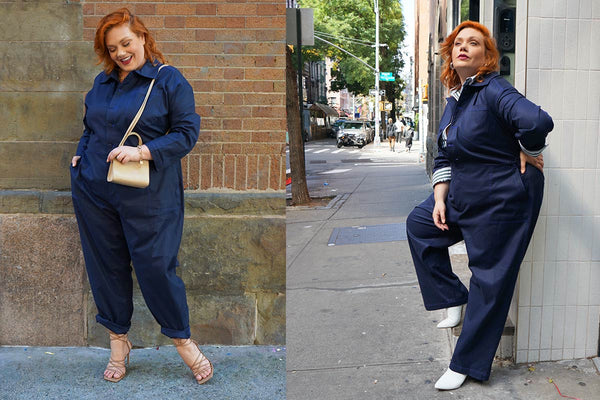 See ROSE Go Plus Size model wearing the navy blue jumpsuit, styled with nude color sandals and tiny handbag