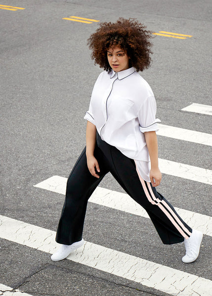See ROSE Go model wearing the Signature Tunic Shirt half tucked into the Tailored Track Pants size 14-28