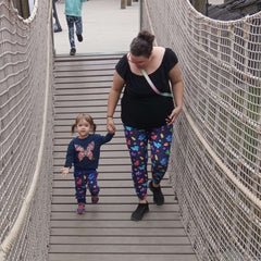 Mother and child wearing matching leggings.