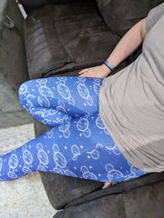 Woman wearing Doctor Who themed design leggings.