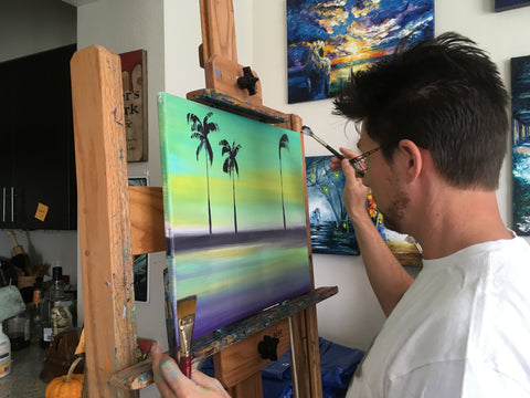 Artist at work painting Tropical Scenes