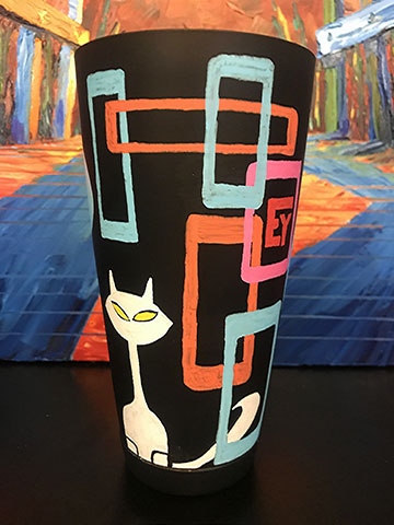 Mid-century retro cool cat Tiki barware with a white cat on a black blackground with colorful atomic details. Hand-painted for El Yucateco Hot Sauce by Nelson Ruger.