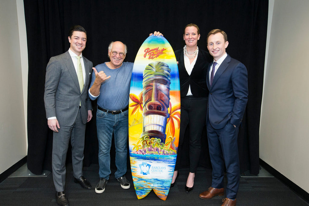 Jimmy Buffett with the surfboard painted by Nelson