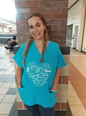 Lady wearing a positive-message-shirt scrub Top