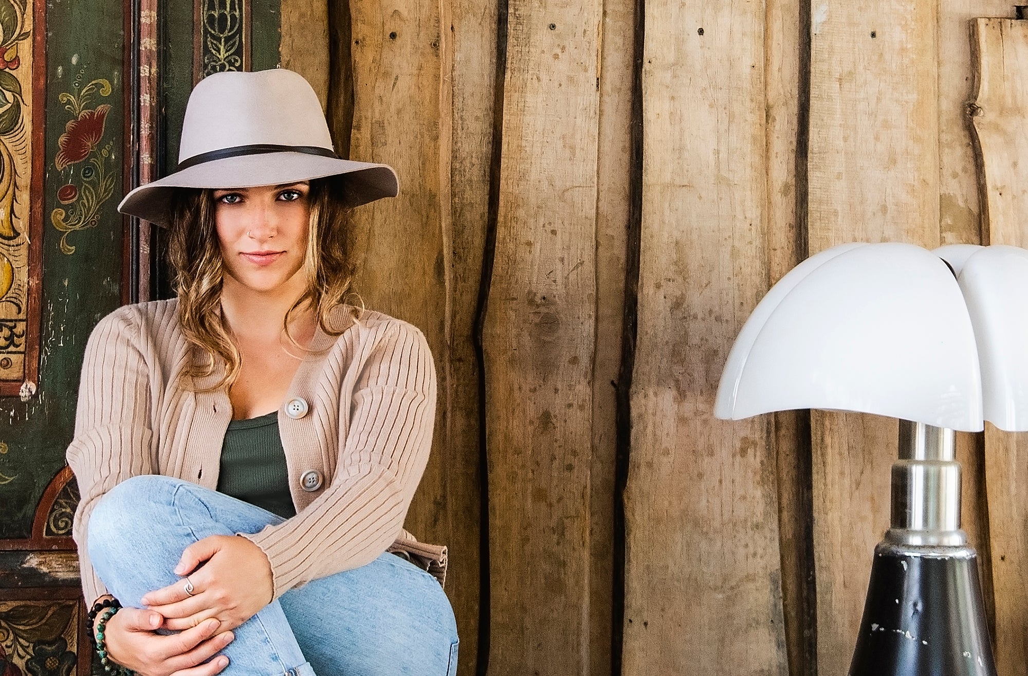 Woman Wearing a Wallaroo Aspen Winter Sun Hat while sitting