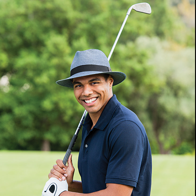 Man ready to swing a golf club on the course standing Wearing a Carkella Fairway Summer Sun hat 