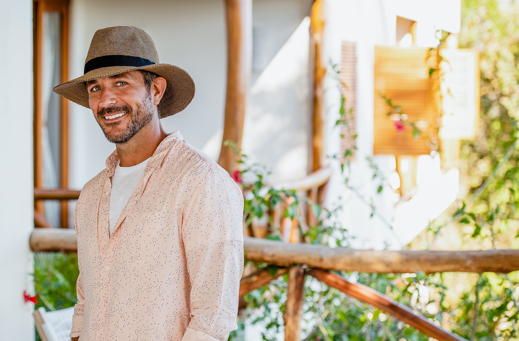 Man standing relaxed on a jungle path Wearing a Carkella Parker Fedora Poly-straw Fedora Sun Hat with hands at his side