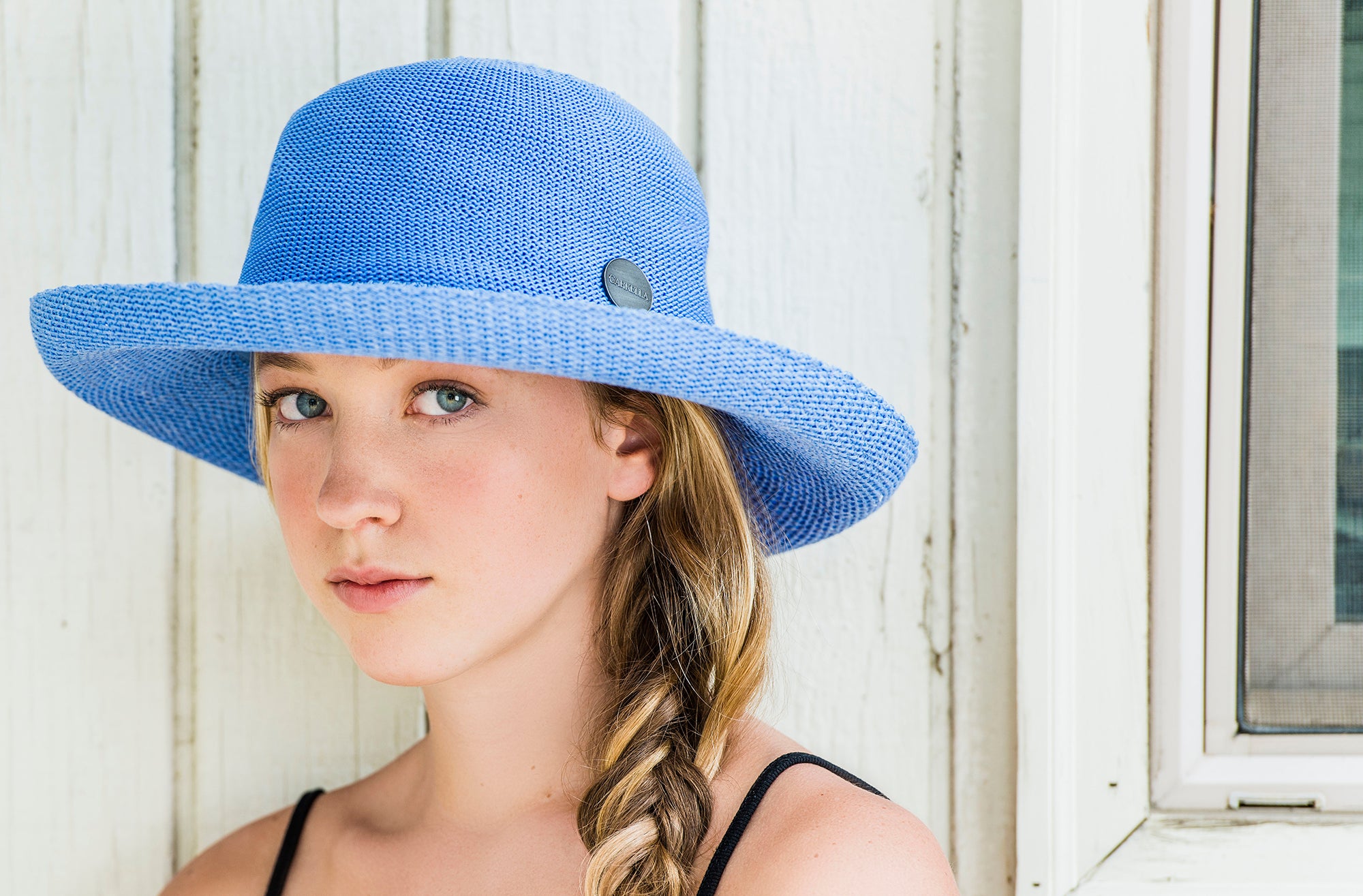 Woman smiling while Wearing a Carkella Victoria Poly-straw big wide brim summer sun hat 