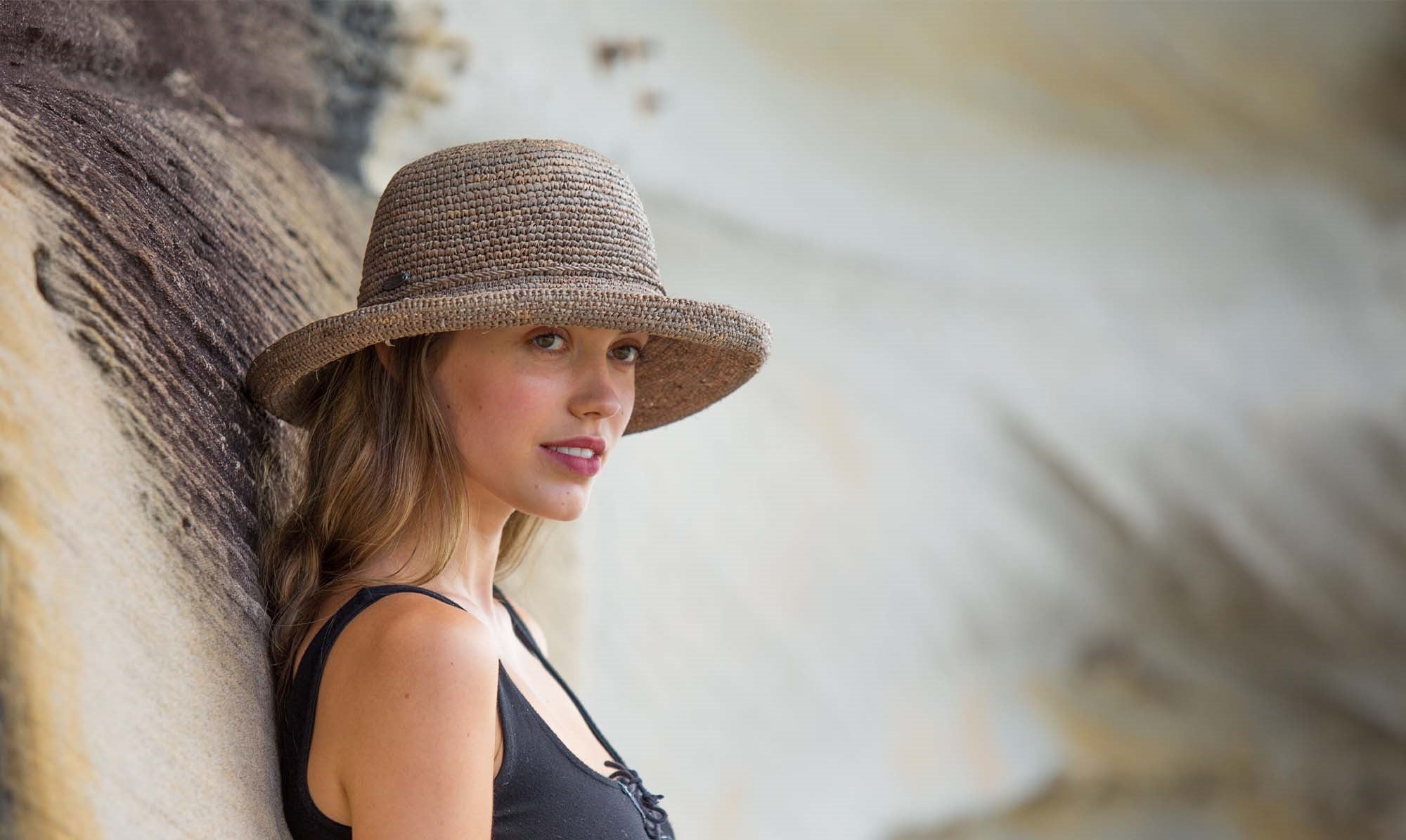 Woman Wearing a Wallaroo Catalina Straw Sun Hat with a big wide brim in front of a Tree