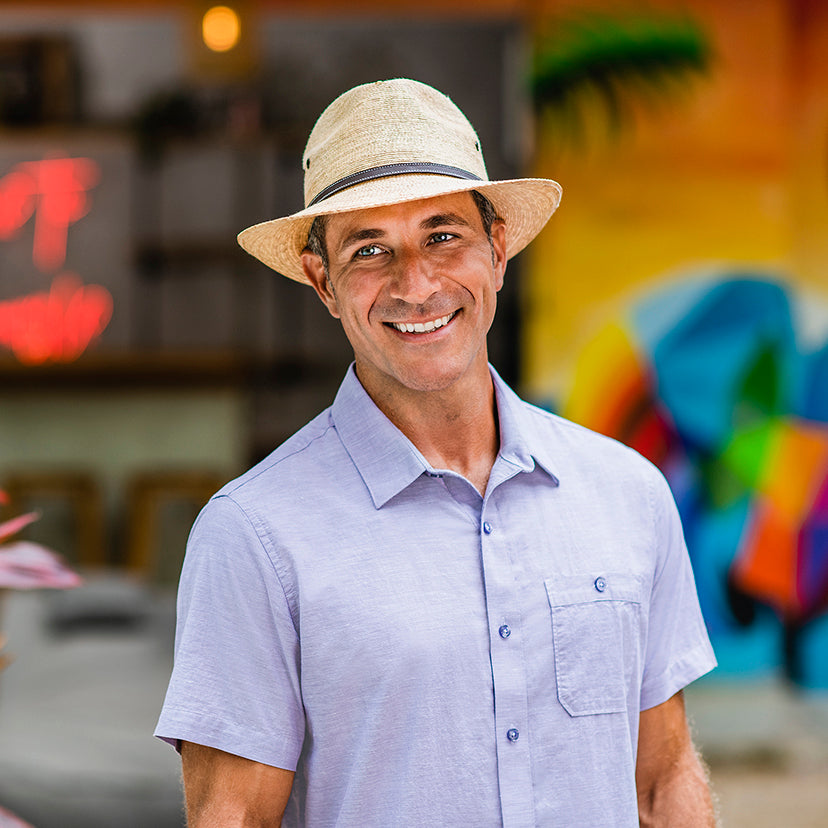 Man outside wearing the artisan Cortez fedora straw sun beach hat by Wallaroo