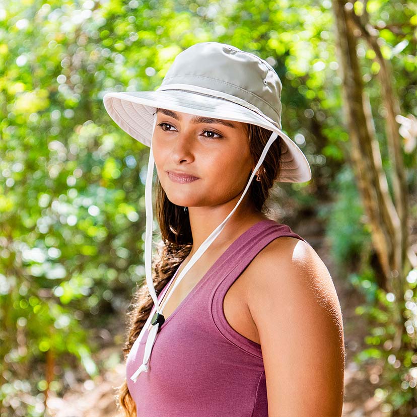 Woman Wearing a Wallaroo Ladies' Explorer Bucket Beach Hat with Chinstrap on a Hike