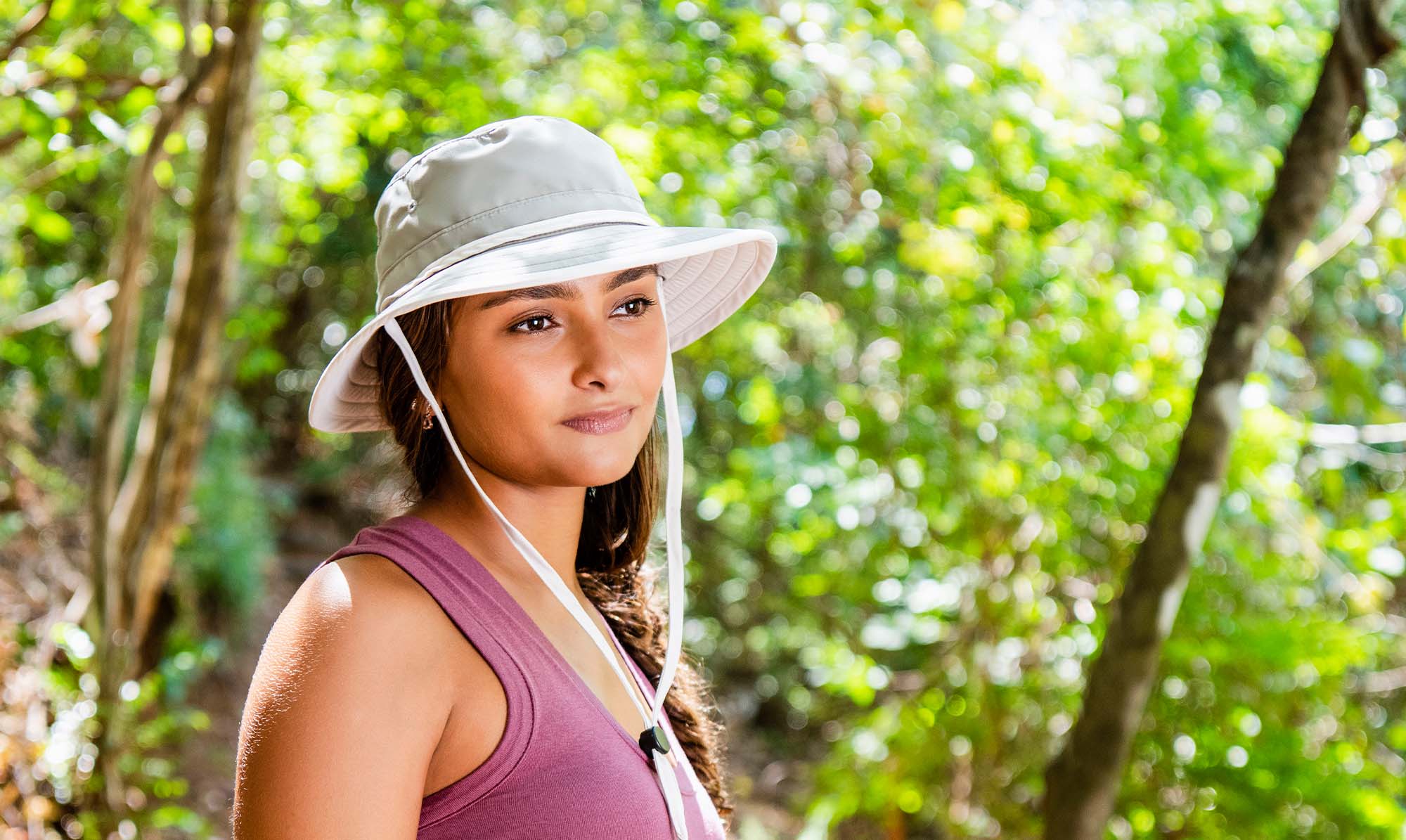 Woman Wearing a Wallaroo Ladies' Explorer Bucket Beach Hat with Chinstrap on a Hike