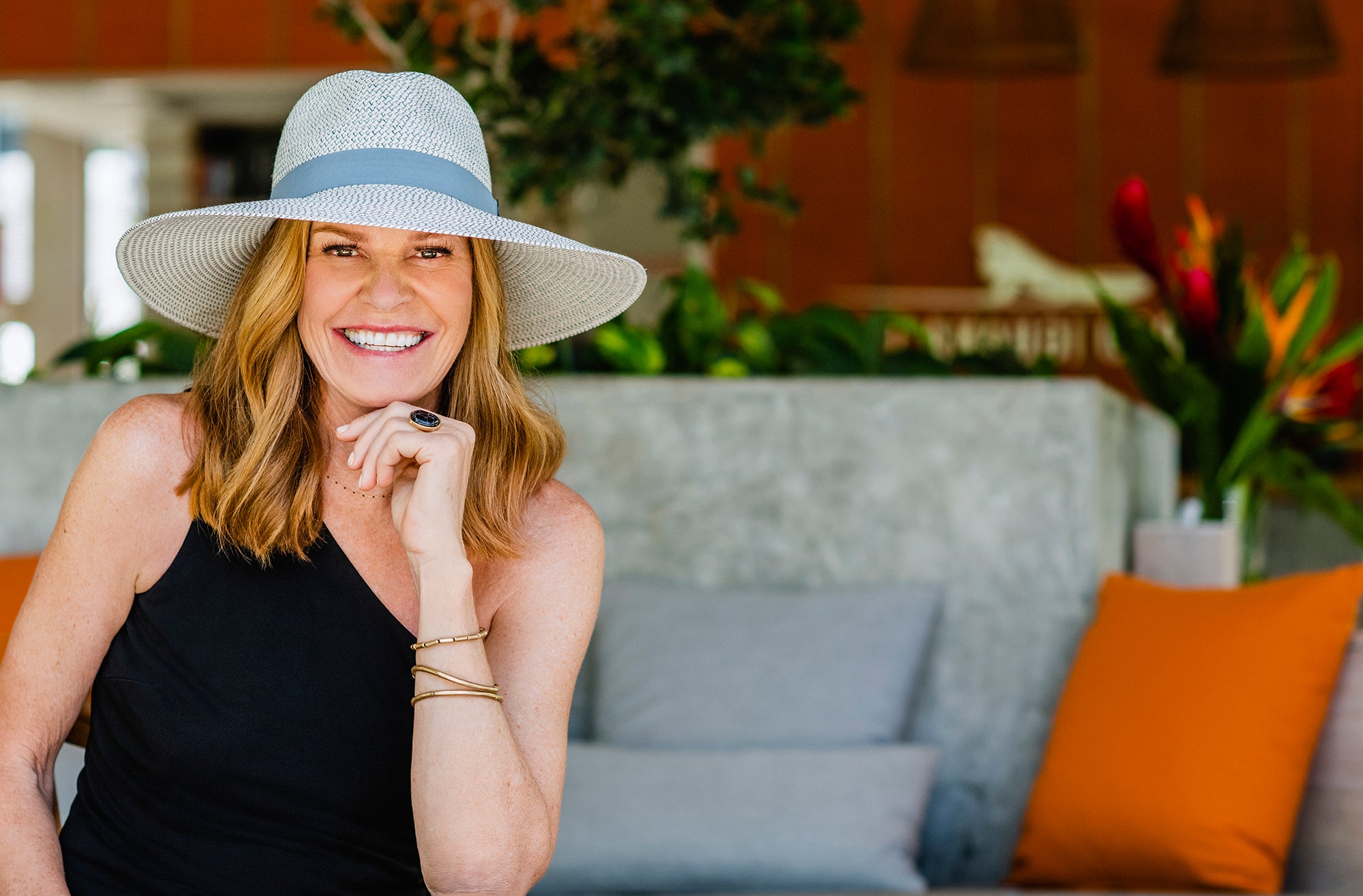 Woman smiling while wearing the Kerrigan UPF summer sun hat with a big wide brim 