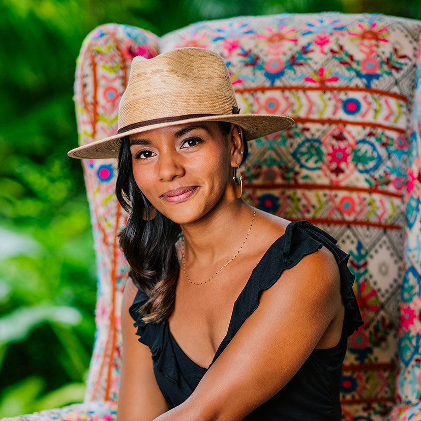 Woman sporting the aristan big wide brim Marina sun hat by Wallaroo, with uv protection