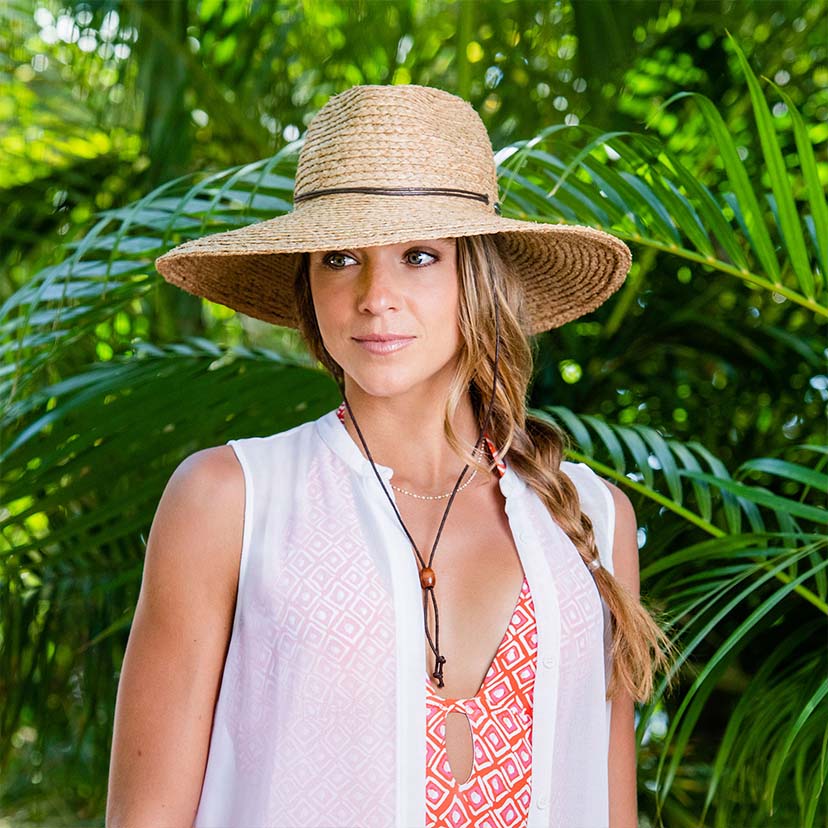 Woman Wearing a Wallaroo Nosara Straw Sun Hat with a big wide brim and uv protection in a Jungle