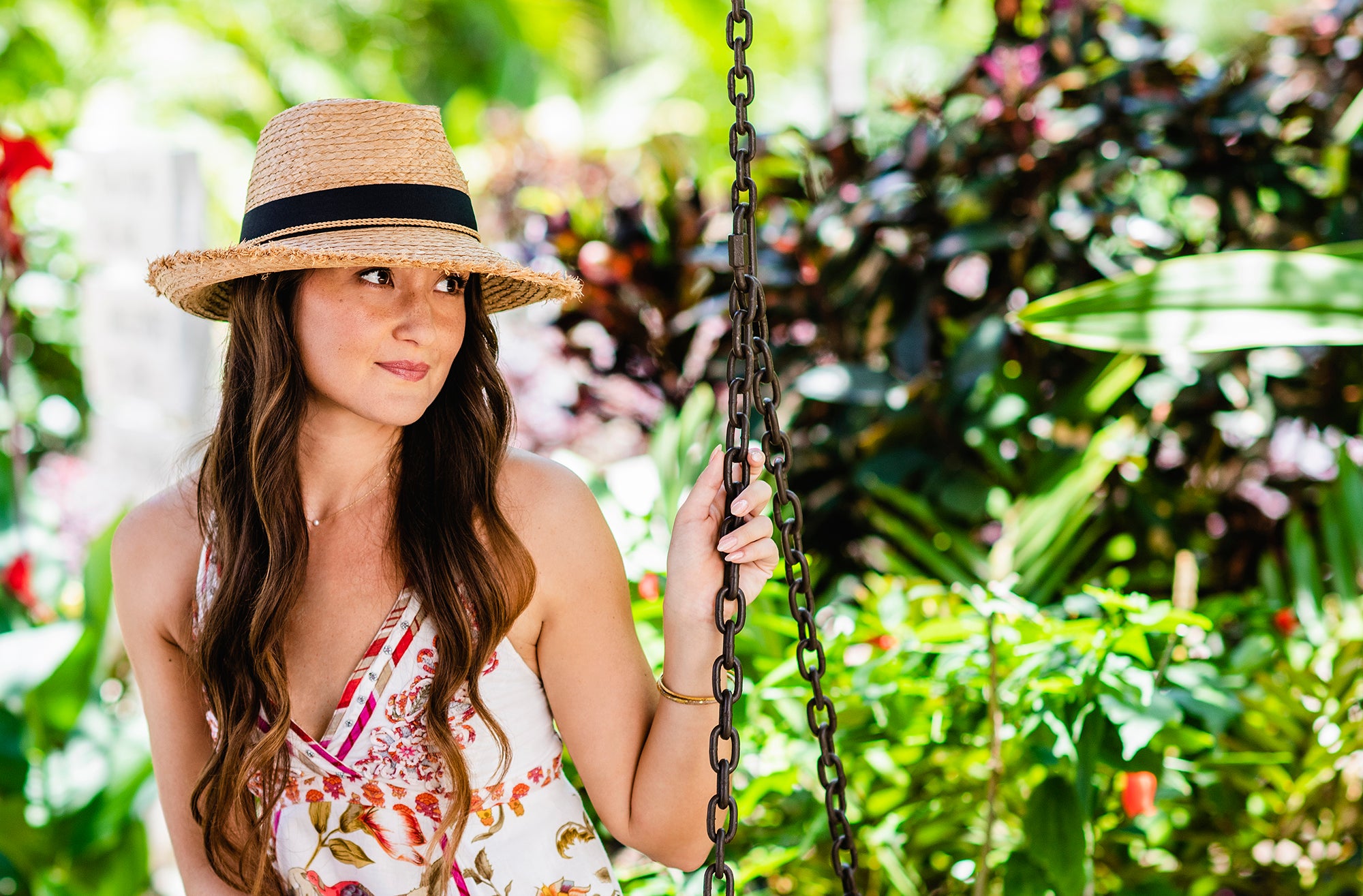 Woman outside wearing the Paloma by Wallaroo, a summer beach straw hat