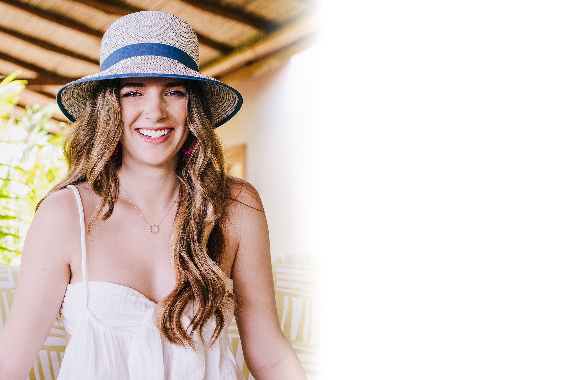 Woman on couch sitting while wearing the Petite Darby bucket style summer sun hat