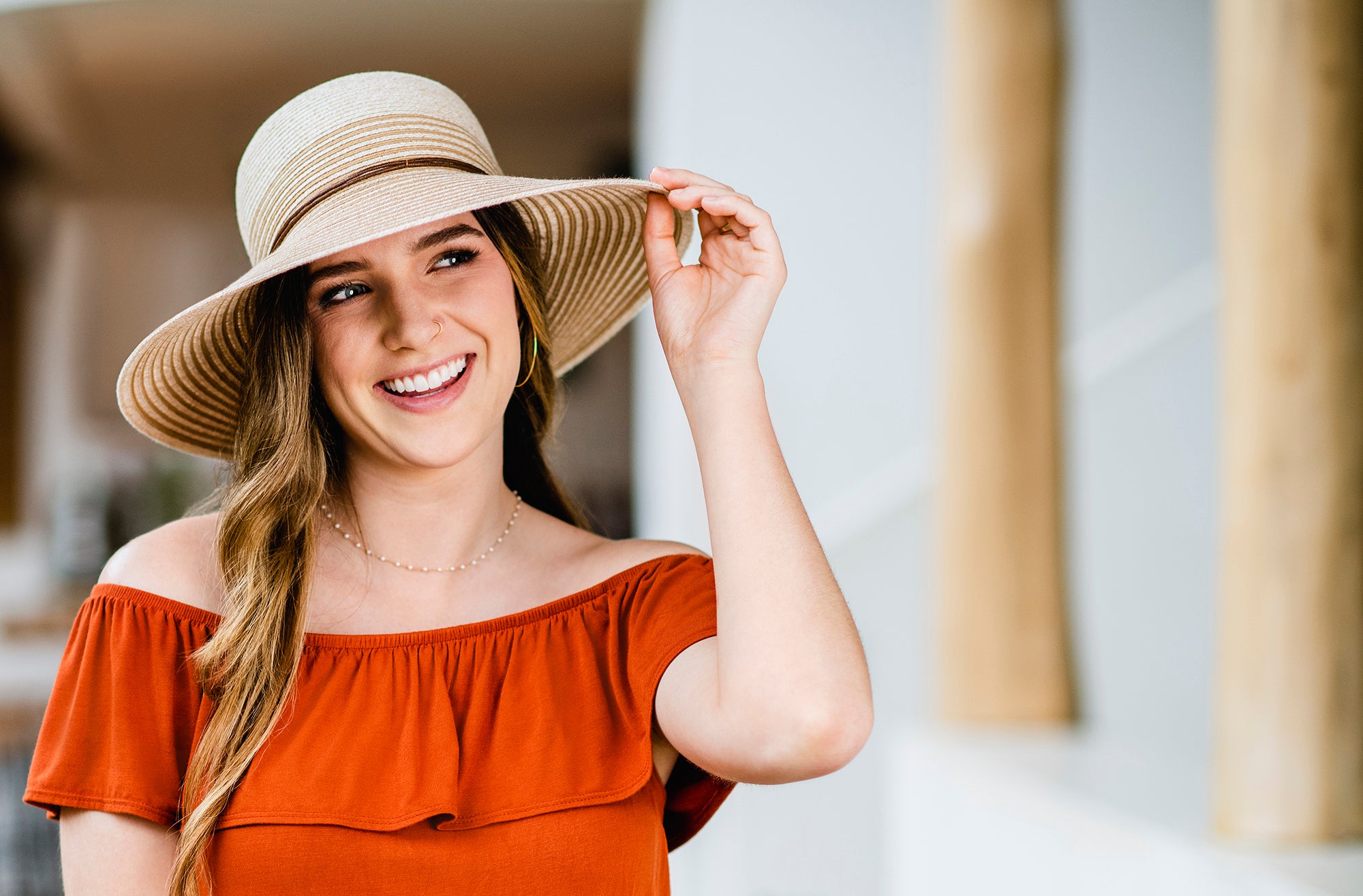 Woman wearing the petite marseille summer sun hat with uv protection