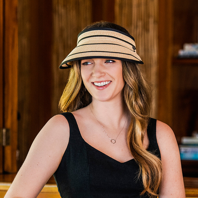 Woman smiling and wearing a packable petite savannah sun visor