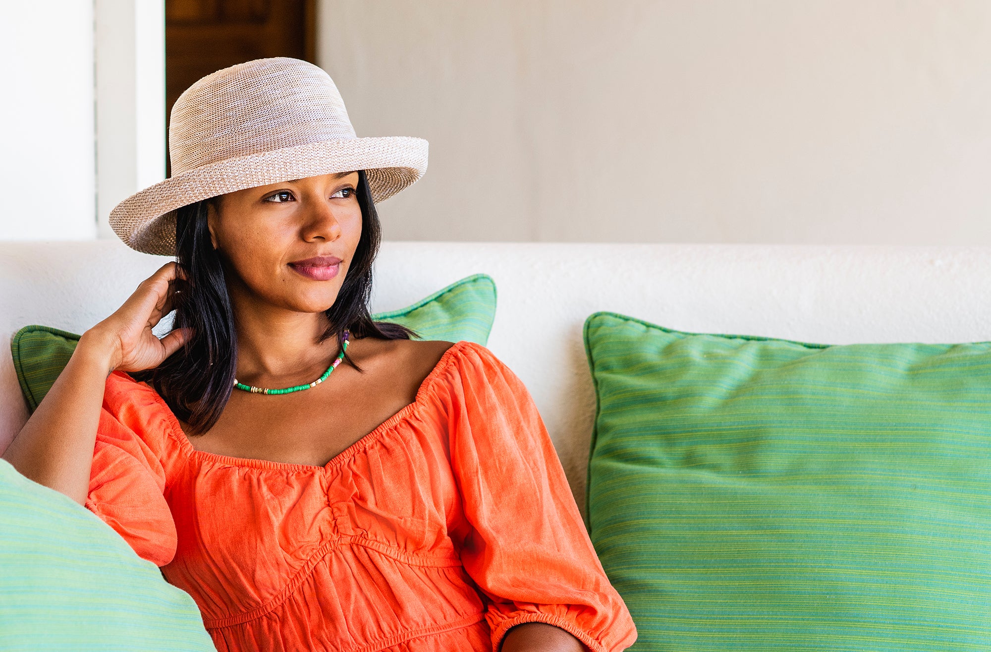 Woman Wearing a Wallaroo Petite Victoria poly-straw summer hat with a big wide brim