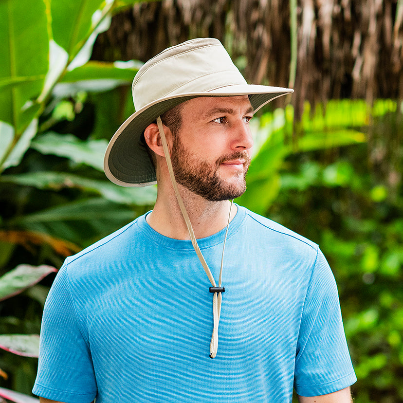 Man outdoors with the Summit summer sun hat by Wallaroo, with uv protection designed for travel