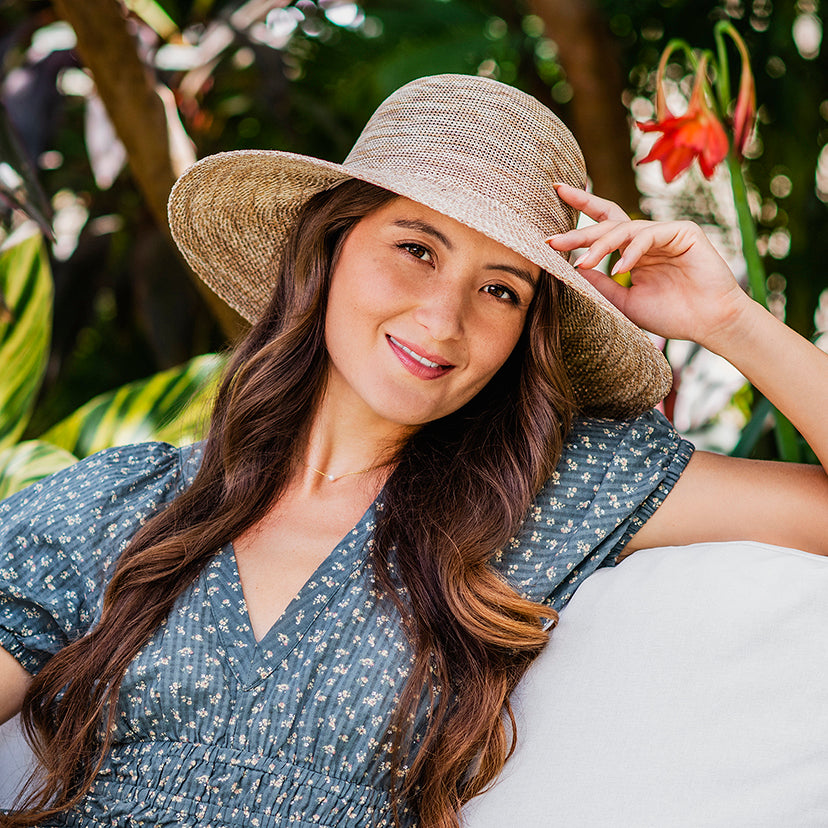 Woman wearing a Wallaroo Victoria Diva summer sun hat with a big wide brim 